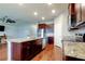 Bright kitchen features granite countertops, dark cabinetry, and stainless steel appliances at 5920 Silver Palm Blvd, Bradenton, FL 34211
