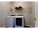 Laundry room featuring white washer and dryer with overhead storage at 5920 Silver Palm Blvd, Bradenton, FL 34211
