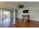 Spacious living room boasts wood floors, a ceiling fan, and sliding glass doors to the lanai at 5920 Silver Palm Blvd, Bradenton, FL 34211