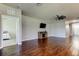 The open living room has hard wood floors, a ceiling fan, a fireplace and mounted television at 5920 Silver Palm Blvd, Bradenton, FL 34211