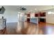 Open-concept living area with wood floors, connecting to a modern kitchen and dining space at 5920 Silver Palm Blvd, Bradenton, FL 34211