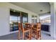 Spacious covered patio featuring a dining table, hot tub, and access to the home's interior at 5920 Silver Palm Blvd, Bradenton, FL 34211