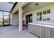 Covered patio with ceiling fan, hot tub, and seating is the perfect place to relax outdoors at 5920 Silver Palm Blvd, Bradenton, FL 34211