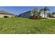 Spacious side yard with lush green grass, providing ample space for outdoor activities at 5920 Silver Palm Blvd, Bradenton, FL 34211