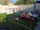 Lush backyard featuring artificial turf, a variety of colorful play structures and patio shade at 611 N Bradford Ave, Tampa, FL 33609