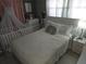 Bright bedroom with crib, white furniture and good light at 611 N Bradford Ave, Tampa, FL 33609