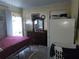 Bedroom with a comfortable bed, dresser, and convenient access to the outdoors at 611 N Bradford Ave, Tampa, FL 33609