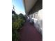 Exterior side view with paved walkway and mature landscaping at 611 N Bradford Ave, Tampa, FL 33609