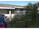 Exterior view of home with manicured lawn, mature landscaping, and driveway at 611 N Bradford Ave, Tampa, FL 33609