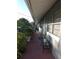Inviting front porch features lovely plants, brick flooring, and a convenient bench for relaxing at 611 N Bradford Ave, Tampa, FL 33609