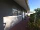 Charming covered walkway featuring brick flooring and lovely landscaping for enhanced curb appeal at 611 N Bradford Ave, Tampa, FL 33609