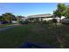 Single-story home with a well-kept lawn and mature landscaping, creating a cozy outdoor space at 611 N Bradford Ave, Tampa, FL 33609