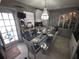 Eat-in kitchen with modern appliances, chandelier and access to backyard at 611 N Bradford Ave, Tampa, FL 33609