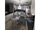 Bright kitchen and dining area featuring stainless appliances, granite counters, and chandelier lighting at 611 N Bradford Ave, Tampa, FL 33609
