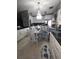 Bright kitchen and dining area featuring stainless appliances, granite counters, and chandelier lighting at 611 N Bradford Ave, Tampa, FL 33609