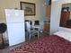 Practical kitchenette with appliances, alongside a small dining area and relaxed bedroom space at 611 N Bradford Ave, Tampa, FL 33609