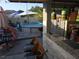 Outdoor patio featuring a bar area, pendant lighting, and a view of the pool at 611 N Bradford Ave, Tampa, FL 33609