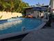 Backyard pool with a swan float, landscaping, and privacy fence at 611 N Bradford Ave, Tampa, FL 33609