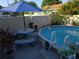 Backyard pool area with picnic table, ladder, and decorative landscaping at 611 N Bradford Ave, Tampa, FL 33609