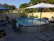 Backyard above-ground pool with patio and lush greenery at 611 N Bradford Ave, Tampa, FL 33609