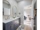 Modern bathroom featuring dual sinks, framed mirrors, and elegant fixtures at 6215 N 44Th St, Tampa, FL 33610