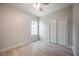 A bright bedroom with light wood floors, a ceiling fan, and a spacious closet at 6215 N 44Th St, Tampa, FL 33610