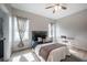 Bright bedroom featuring light wood floors, ceiling fan, natural light, and a convenient desk area at 6215 N 44Th St, Tampa, FL 33610
