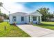 Inviting single-story home with a well-manicured lawn and a long driveway at 6215 N 44Th St, Tampa, FL 33610