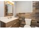 Bathroom with wood grain ceramic tile, neutral walls, wood vanity with white countertop and a framed mirror at 6262 142Nd N Ave # 607, Clearwater, FL 33760