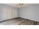 Bedroom with wood-look flooring, ceiling fan with light, closet, and lots of natural light at 6262 142Nd N Ave # 607, Clearwater, FL 33760