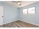 Bedroom with wood-look flooring, natural light, and closet at 6262 142Nd N Ave # 607, Clearwater, FL 33760