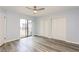 Bedroom with wood-look flooring, ceiling fan with light, closet, slider, and lots of natural light at 6262 142Nd N Ave # 607, Clearwater, FL 33760