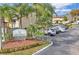 A well-maintained community entrance sign amidst lush landscaping and convenient parking at 6262 142Nd N Ave # 607, Clearwater, FL 33760