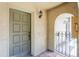 Townhome entryway featuring a decorative door, tiled floor, arched entrance, and classic light fixture at 6262 142Nd N Ave # 607, Clearwater, FL 33760