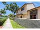 Townhome exterior showcasing its neutral color palette, trimmed windows and textured concrete perimeter wall at 6262 142Nd N Ave # 607, Clearwater, FL 33760