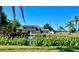 Charming home with a well-maintained lawn and a serene pond featuring a fountain with lush aquatic plants at 6262 142Nd N Ave # 607, Clearwater, FL 33760