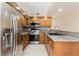The updated kitchen has stainless appliances and wood cabinets and a tile backsplash at 6262 142Nd N Ave # 607, Clearwater, FL 33760