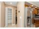 Spacious kitchen adjoins the laundry room with a stainless steel refrigerator at 6262 142Nd N Ave # 607, Clearwater, FL 33760