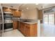 A well-lit kitchen features wooden cabinets, stainless appliances, and a breakfast bar area at 6262 142Nd N Ave # 607, Clearwater, FL 33760