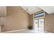 Living room with vaulted ceilings, sliding glass door with outside view, tile flooring, and neutral paint colors at 6262 142Nd N Ave # 607, Clearwater, FL 33760