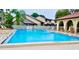 A refreshing community pool with plenty of lounge chairs for relaxing by the clear blue water at 6262 142Nd N Ave # 607, Clearwater, FL 33760