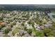 Expansive aerial view of a well-maintained neighborhood with mature trees and community lakes at 627 Belted Kingfisher N Dr, Palm Harbor, FL 34683