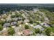 A charming neighborhood features neatly lined streets, lush trees, and well-maintained homes at 627 Belted Kingfisher N Dr, Palm Harbor, FL 34683