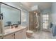 Bright bathroom featuring white tile, a walk-in shower, white sink, vanity, and an outdoor view at 627 Belted Kingfisher N Dr, Palm Harbor, FL 34683