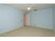 Clean bedroom with carpet, light blue walls, white trim, and a ceiling fan at 627 Belted Kingfisher N Dr, Palm Harbor, FL 34683