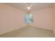 Bedroom with light walls and carpet, window with natural light, and ceiling fan at 627 Belted Kingfisher N Dr, Palm Harbor, FL 34683