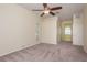 Spacious bedroom features carpet, ceiling fan, neutral walls, and natural light from the window at 627 Belted Kingfisher N Dr, Palm Harbor, FL 34683