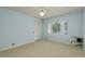 Bedroom with green carpet, neutral walls, a ceiling fan, a window, and a closet with louvered doors at 627 Belted Kingfisher N Dr, Palm Harbor, FL 34683