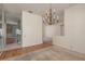 Open dining room area with a decorative chandelier and hardwood flooring, transitioning to other rooms at 627 Belted Kingfisher N Dr, Palm Harbor, FL 34683