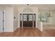 Spacious foyer featuring hardwood floors, decorative doors, and plenty of natural light at 627 Belted Kingfisher N Dr, Palm Harbor, FL 34683
